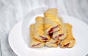 Sweet biscuits with jam on a white plate