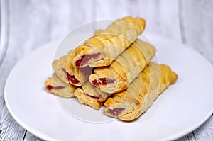 Sweet biscuits with jam on a white plate