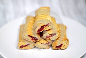 Sweet biscuits with jam on a white plate