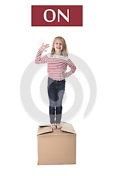 Sweet blond hair child stading on top of cardboard box isolated on white background in learning english