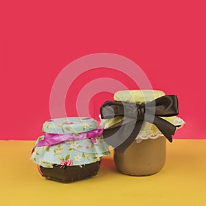 Sweet Brazilian milk and jelly in on pot  on colored background. Fresh colors pastel trend photo