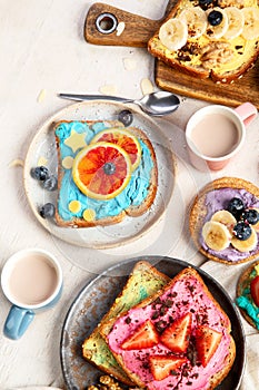 Sweet breakfast with cup of cocoa. Toast with cream cheese, banana, strawberries, blueberries