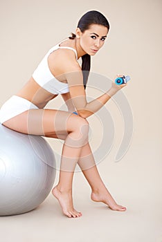 Sweet brunette doing fitness exercises