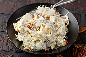 sweet cabbage raisins and pecan nuts salad with creme fraiche