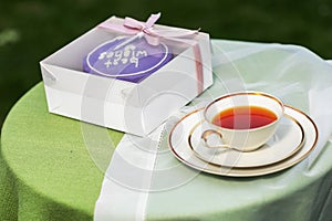 sweet cake with cup of tea and cake on table