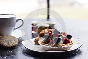 Sweet cake with cup of tea isolated on white