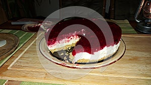 Sweet caloric dessert. Cheesecake on the wooden table.
