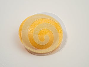 Sweet candies in the shape of a UFO in different colors on a white background.
