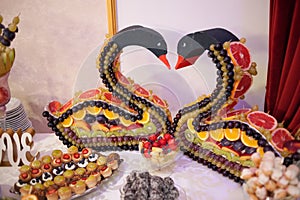 Sweet candy bar.Different delicious fruits and cakes on wedding reception table .