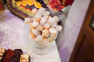 Sweet candy bar.Different delicious fruits and cakes on wedding reception table . photo