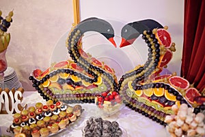 Sweet candy bar.Different delicious fruits and cakes on wedding reception table . photo