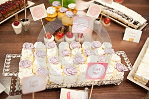 Sweet candy bar.Different delicious fruits and cakes on wedding reception table . photo
