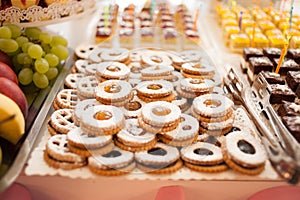 Sweet candy bar.Different delicious fruits and cakes on wedding reception table . photo