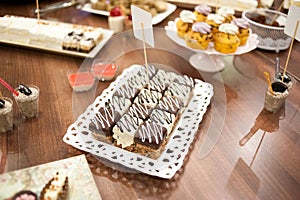 Sweet candy bar.Different delicious fruits and cakes on wedding reception table .