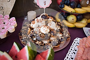 Sweet candy bar.Different delicious fruits and cookies on wedding reception table with bananas . photo