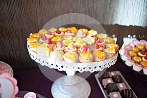 Sweet candy bar.Different delicious fruits and cookies on wedding reception table with bananas and grapes