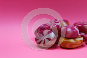 Sweet candy caramel on a pink background piled in a pile