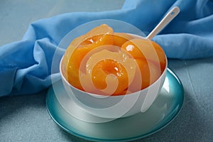 Sweet canned peaches in the ceramic bowl