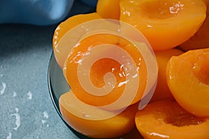 Sweet canned peaches in the ceramic bowl