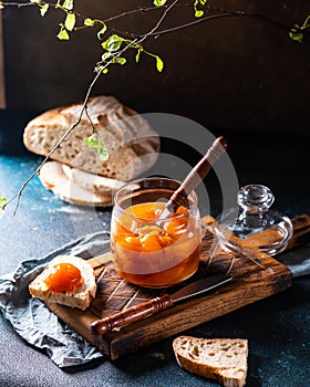 Sweet canned peaches in a jar. Peach jam. Homemade jam. Sweet dessert. Peach marmalade. Vegetarian food. Vegan food concept.