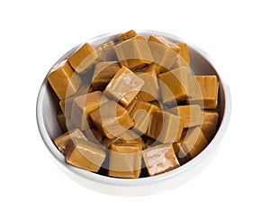 Sweet caramels in white bowl