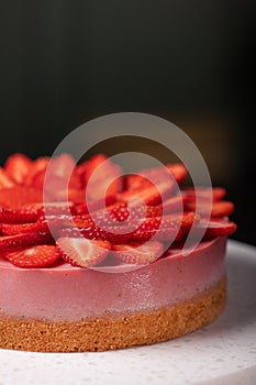 Sweet cheesecake with strawberries fruit on a stone table