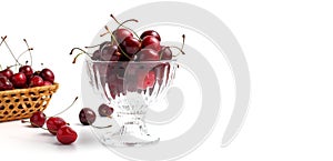 Sweet cherries in a glass vase on white, concept for a banner or flyer to advertise healthy food and fruits. Place for text, copy