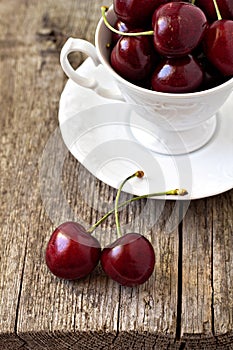 Sweet cherries in a white cup