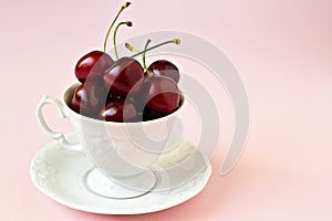 Sweet cherries in a white cup