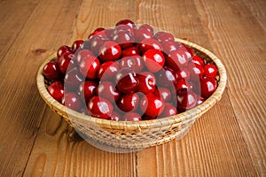 Sweet cherry berries (Prunus avium) in wicker plate