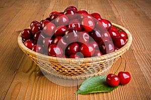 Sweet cherry berries (Prunus avium) in wicker plate