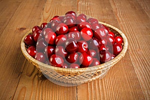 Sweet cherry berries (Prunus avium) in wicker plate photo