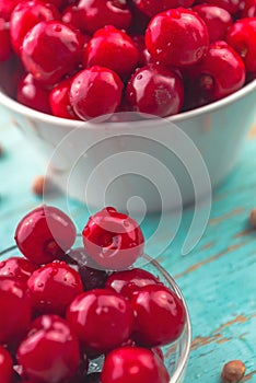 Sweet Cherry in Bowl on Rustic Table photo