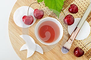 Sweet cherry juice, cosmetic brush, handmade cotton eye patches and cotton pads. Ingredients for preparing homemade mask