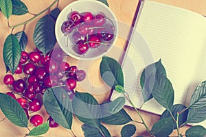 Sweet cherry and notebook for daily records