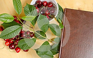 Sweet cherry and notebook for daily records