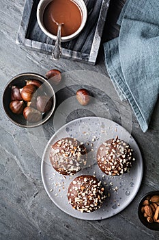 Sweet chestnut cups filled with soft curd cheese, chestnut puree and ground almonds, topped with chocolate frosting and chopped nu