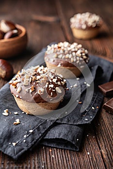 Sweet chestnut cups filled with soft curd cheese, chestnut puree and ground almonds, topped with chocolate frosting and chopped nu