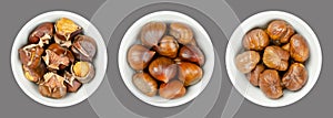 Chestnuts, unshelled, roasted and boiled marrons, in white bowls over gray photo