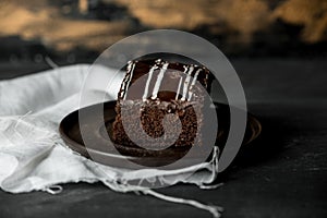 Sweet chocolate brownie with coffe cream on a dark, rustic, wooden table