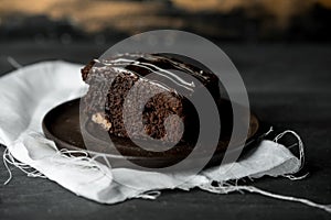 Sweet chocolate brownie with coffe cream on a dark, rustic, wooden table