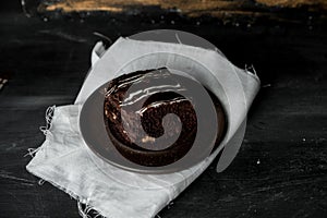 Sweet chocolate brownie with coffe cream on a dark, rustic, wooden table