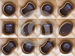 Sweet chocolate candies assortment in a box close-up. Top view