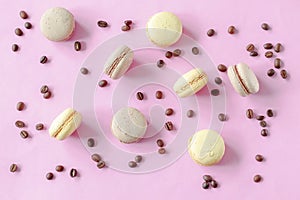Sweet chocolate,lemon macarons with coffee beans lying on pink background, pastry, confectionery desserts, tasty sugar food.copy