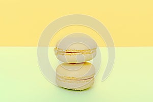 Sweet chocolate,lemon macarons on yellow background, pastry, confectionery desserts, tasty sugar food.copy space