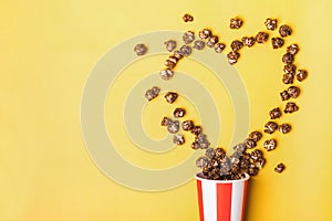 Sweet chocolate popcorn in paper striped white red cup