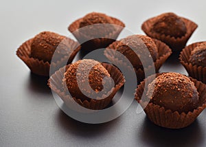 Chocolate pralines over black background
