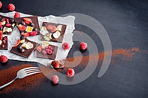 Sweet chocolate slices with fruits on white paper with fruit on plate, sweet dessert on black background. image for patisserie