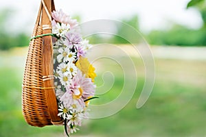 Sweet color flowers in wooden basket hanging in garden