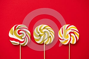 Sweet colorful lolly pops on red